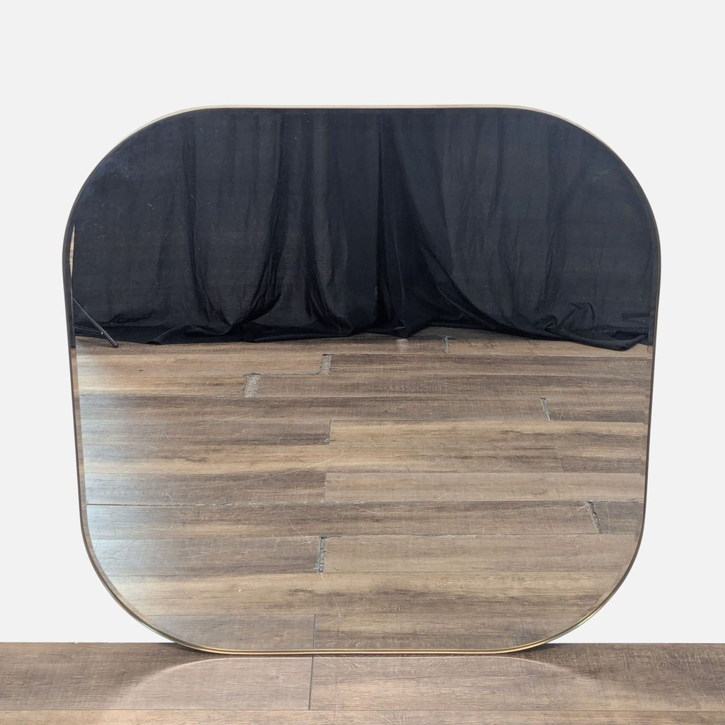 1. Front view of a Crate and Barrel mirror featuring rounded corners and a slim, metallic frame on a wood floor.