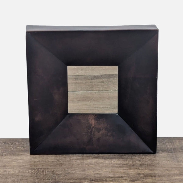1. Square Crate & Barrel mirror with wide, dark metallic frame and small centered reflective surface on wood.