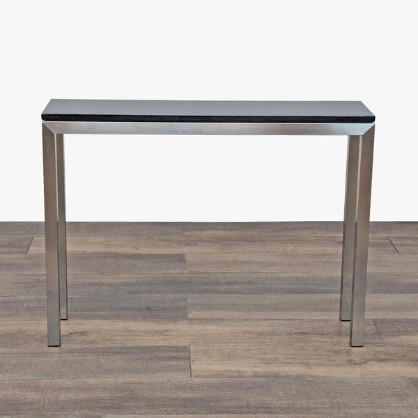 1. Rectangular Room & Board Skinny side table with a black top and steel legs on wood flooring.  