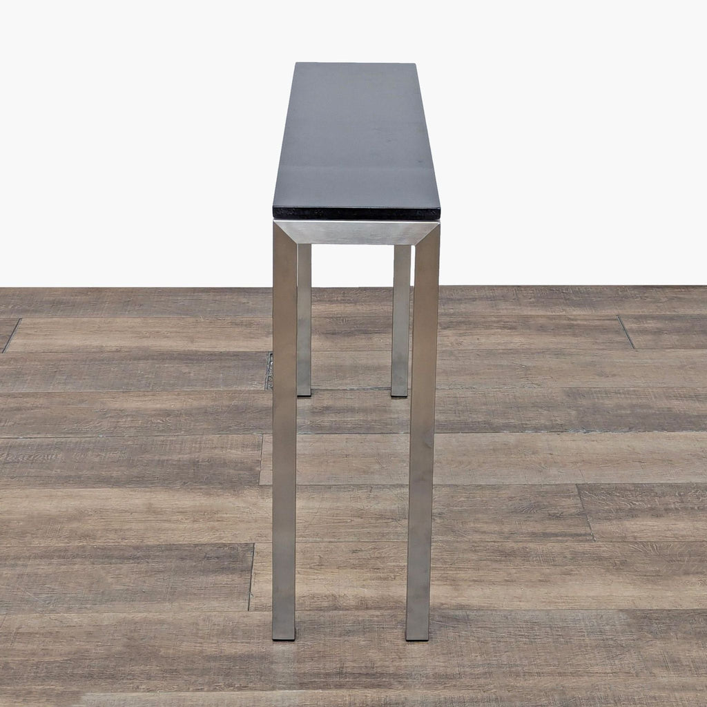 2. Slim console table by Room & Board, featuring a narrow black surface and brushed steel frame.  