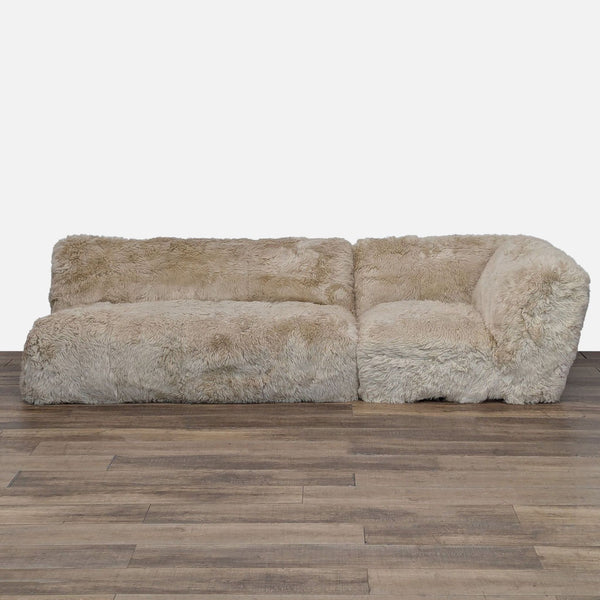 1. Front view of a Restoration Hardware sectional with plush, natural New Zealand sheepskin upholstery.
