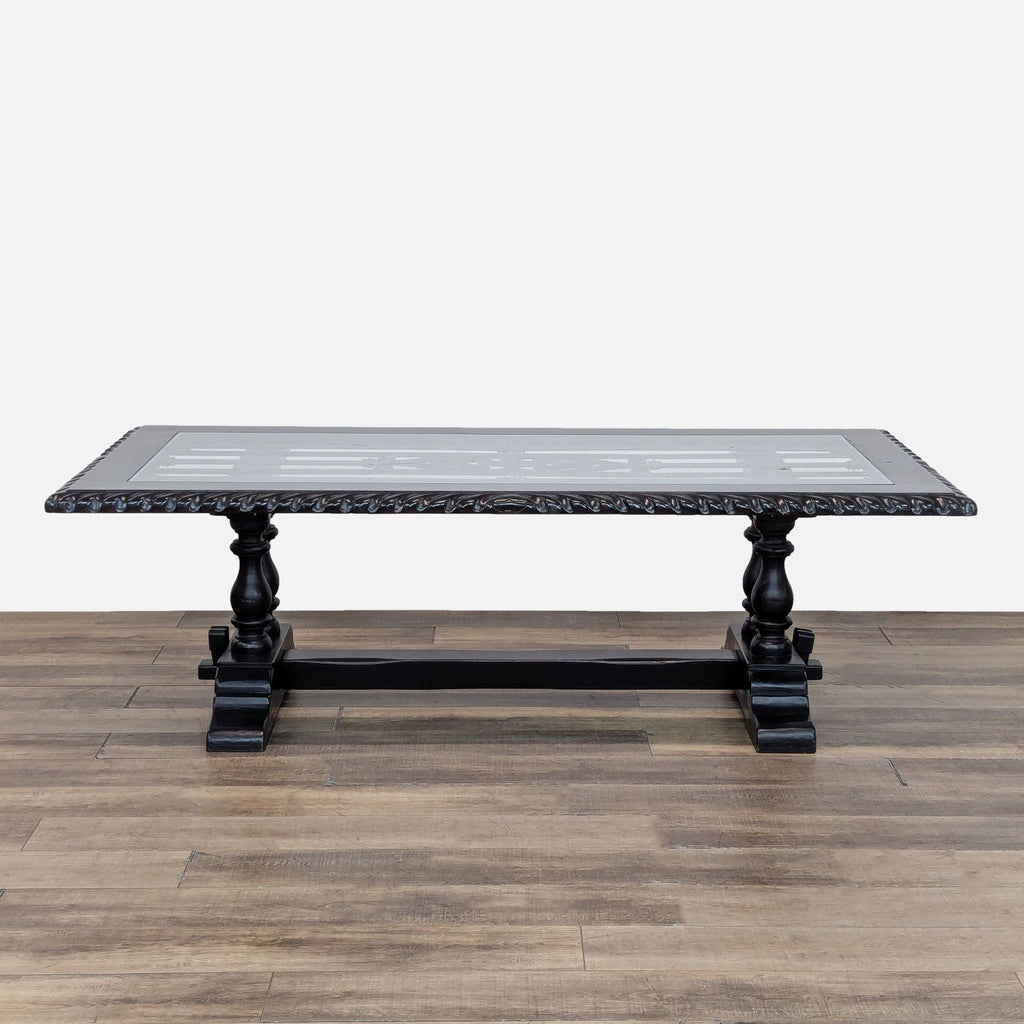 1. Hand-carved Reperch dining table featuring a wrought iron panel beneath a glass top, trestle base design.  