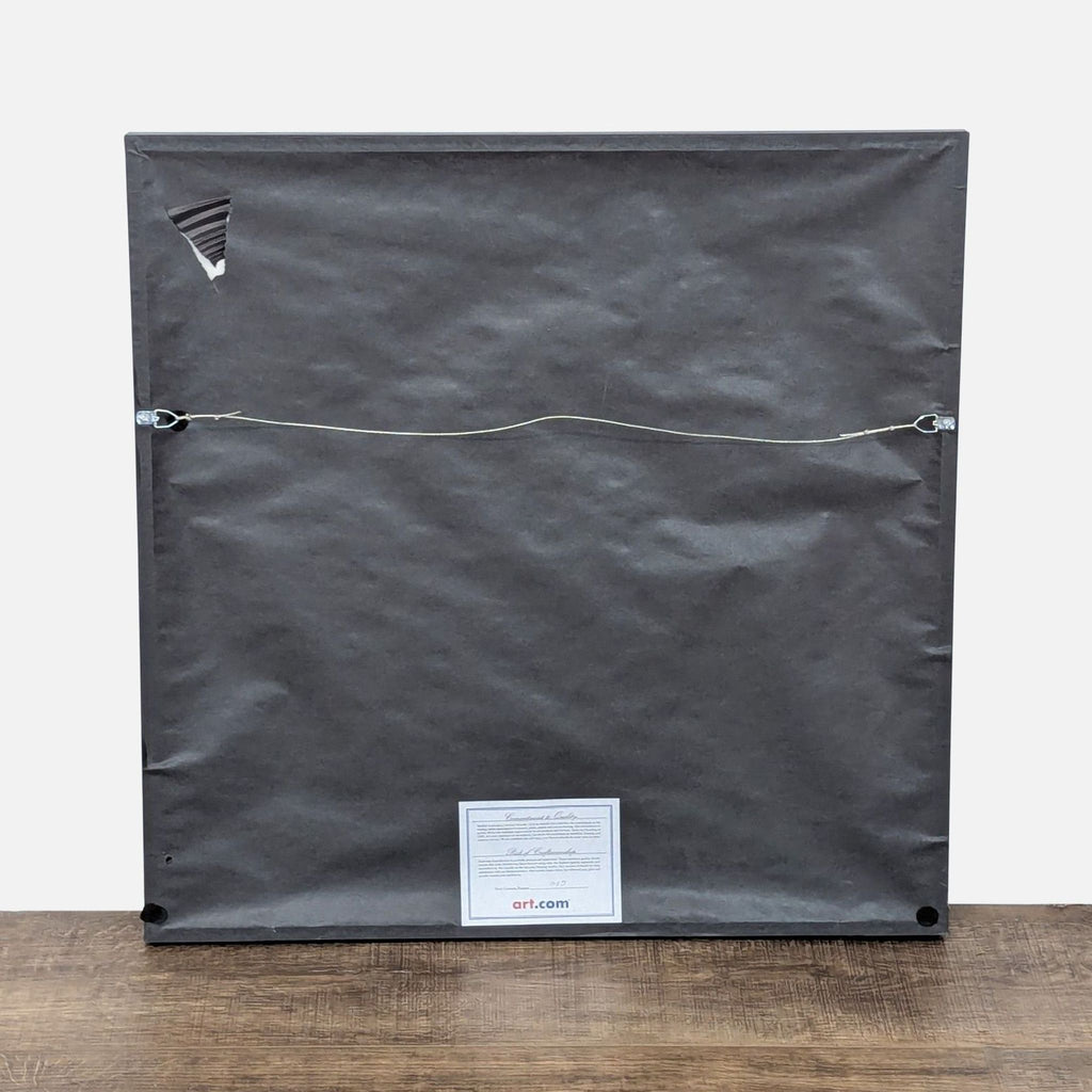 2. Back view of a framed Reperch artwork from Art.com, showing hanging wire and a label.