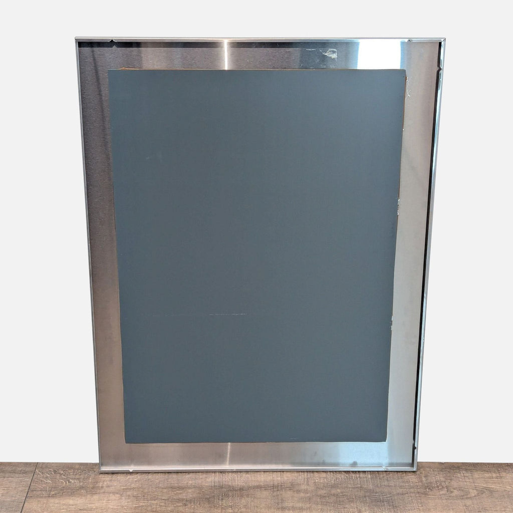 2. Back view of a Room and Board mirror showing a solid metal frame and a flat mounting surface.