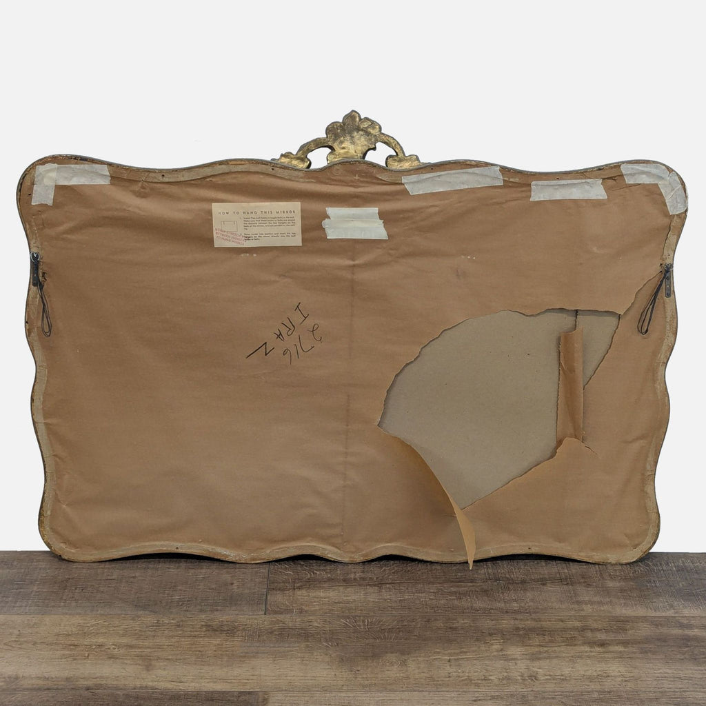 2. Back view of Reperch mirror showing brown paper backing with a torn section and visible hanging instructions.