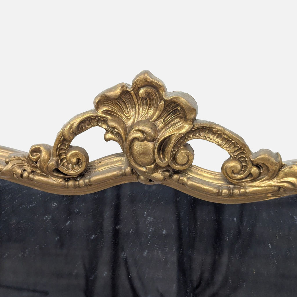 3. Close-up of decorative gold floral and scrollwork detail on the top center of the Reperch mirror frame.
