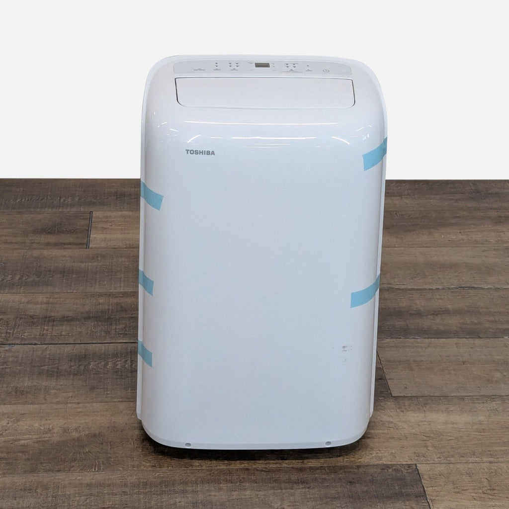 Front view of Toshiba portable air conditioner with digital controls, ideal for cooling small to medium spaces.