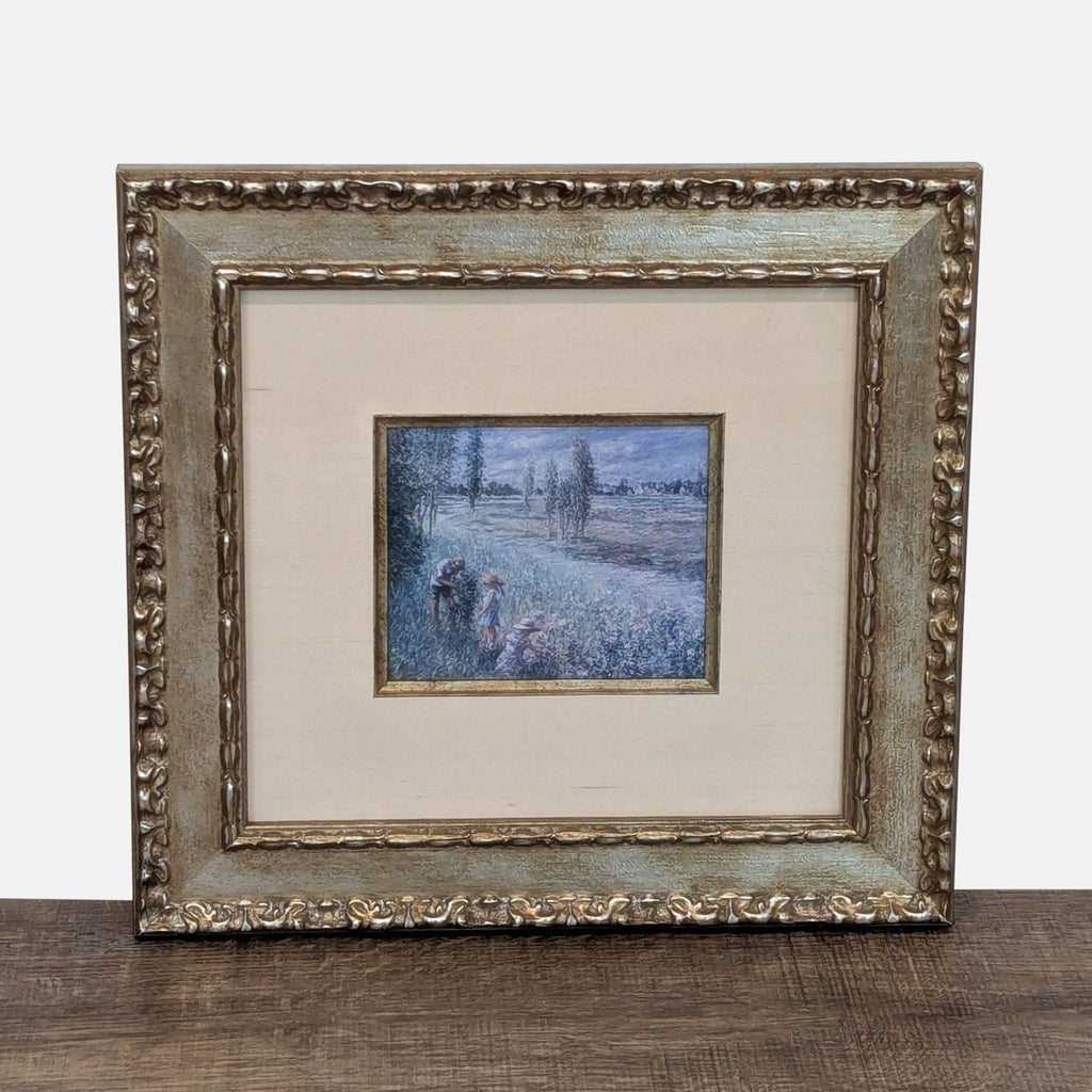 1. Art print of people in a country landscape, set in an ornate gold Reperch frame, seen from the front.