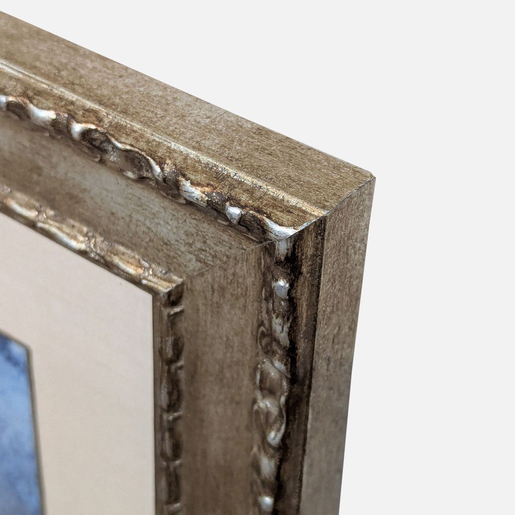 Detail of the ornate gold frame from Reperch, highlighting its intricate raised decorative edging.