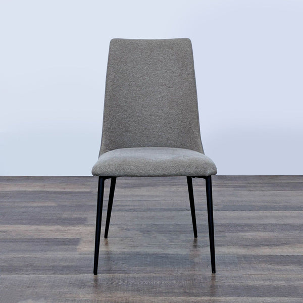 1. Front view of an Interial dining chair with fabric seat, faux leather backrest, and steel legs on wood floor.