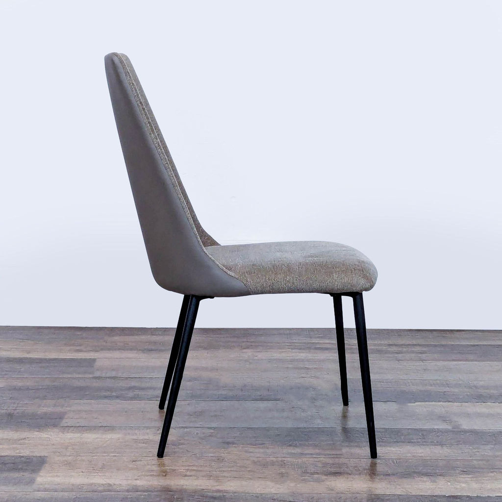 3. Profile view of an Interial dining chair, showing fabric inside, synthetic leather outside, and steel legs.