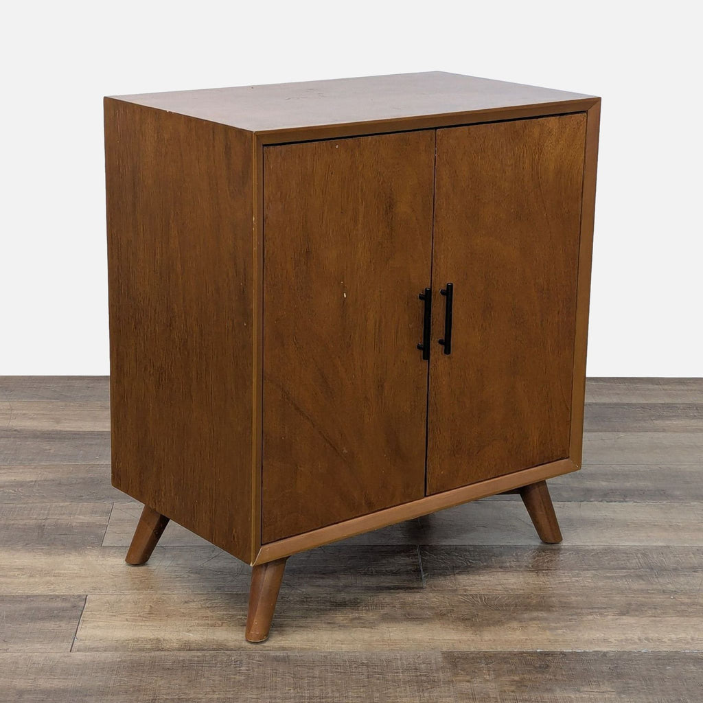 3. Angled view of West Elm eucalyptus wood cabinet with minimalist design and oil-rubbed bronze handles.