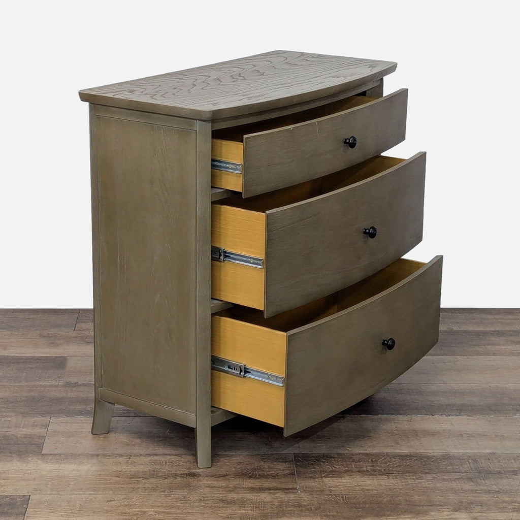Side view of Williams-Sonoma dresser showing three open drawers on metal glides with metal pulls.  