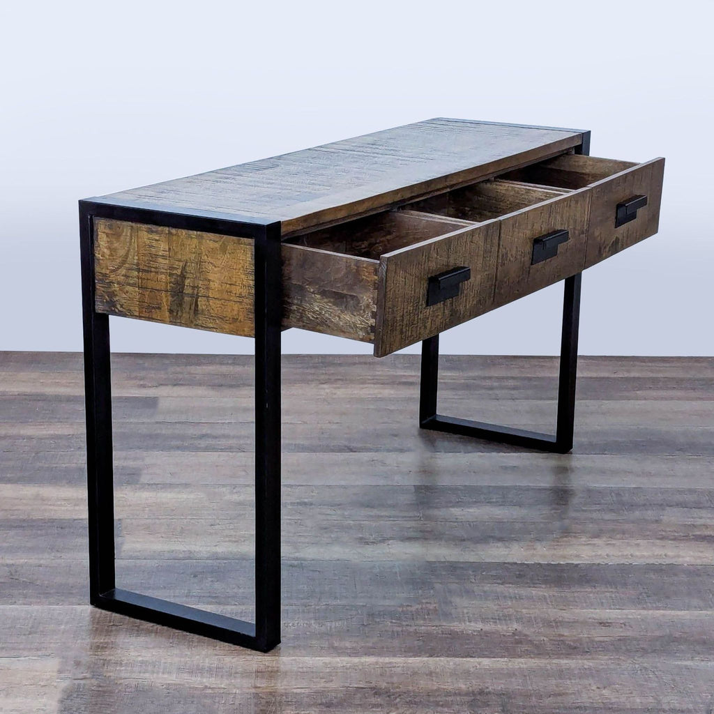 2. Reperch console table made from reclaimed wood, metal sled legs, and open drawers for storage.