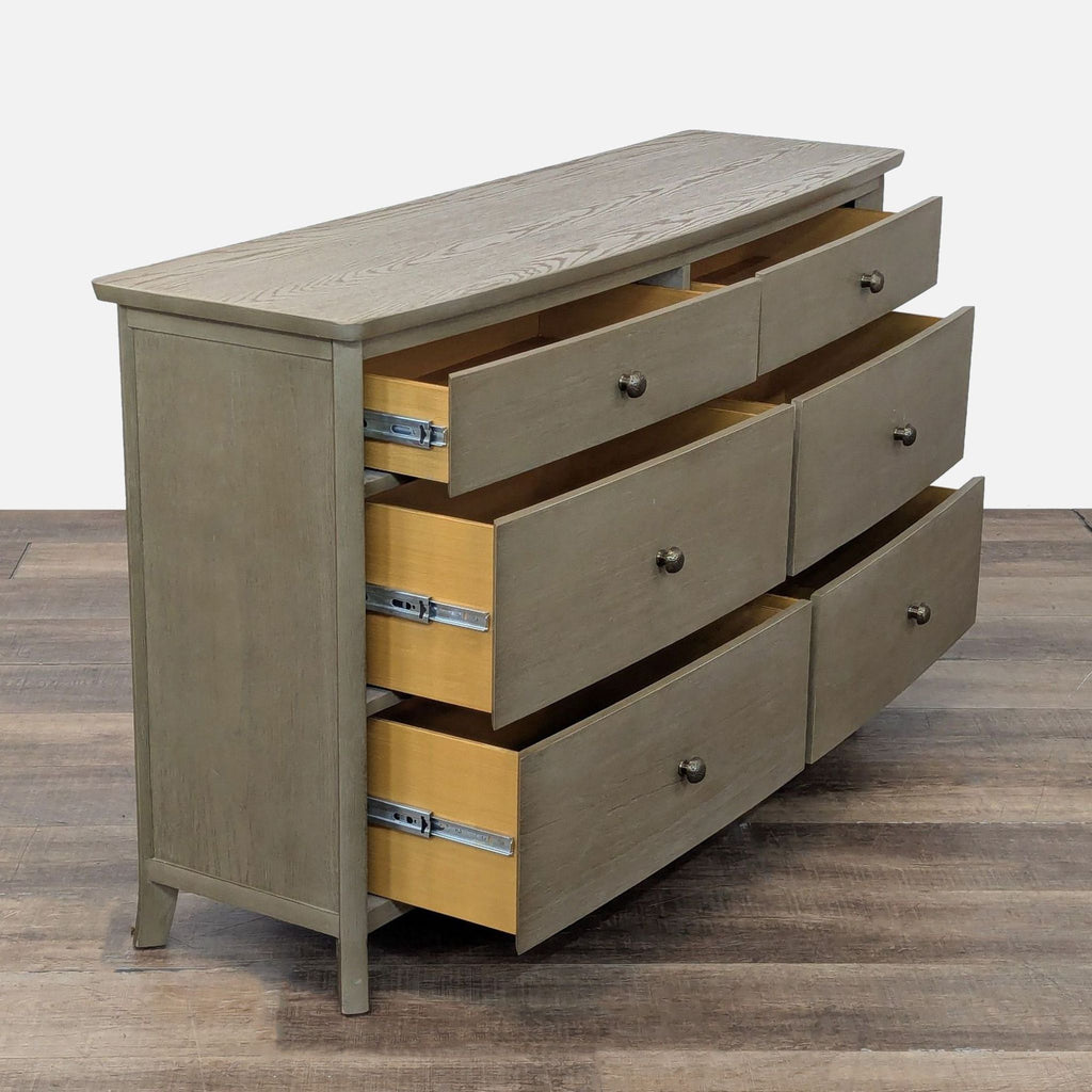 2. Side view of Williams-Sonoma dresser, drawers open on metal glides showcasing storage capacity.  