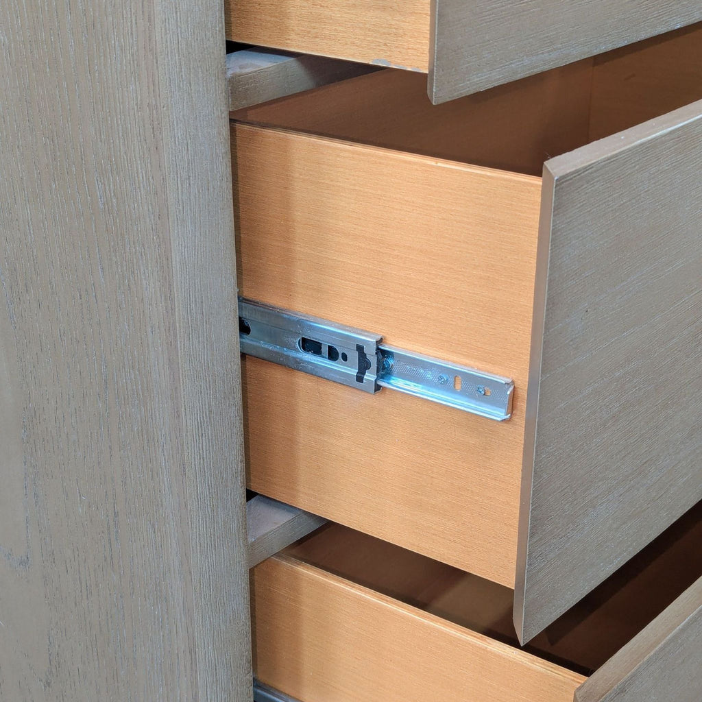 3. Close-up of dresser drawer on metal glide, highlighting interior wood grain and hardware detail.
