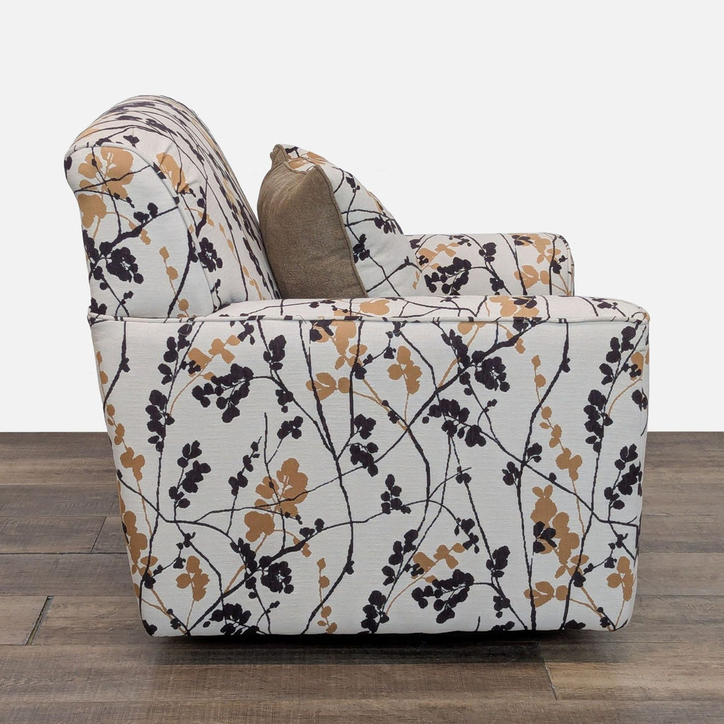 2. Side profile of Ashley Furniture lounge chair in Lounge category, featuring 360-degree swivel and floral upholstery.