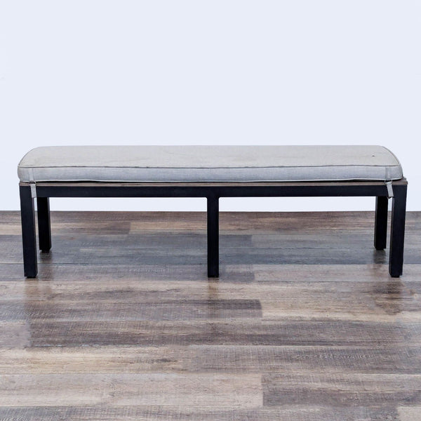 1. Sunbrella aluminum bench with a wood plank top and removable cushion, shown on a wood floor.