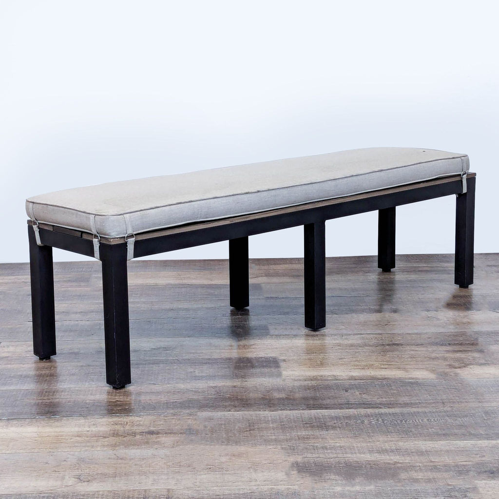 3. Angled view of a rectangular Sunbrella bench featuring a removable cushioned top and sturdy frame.