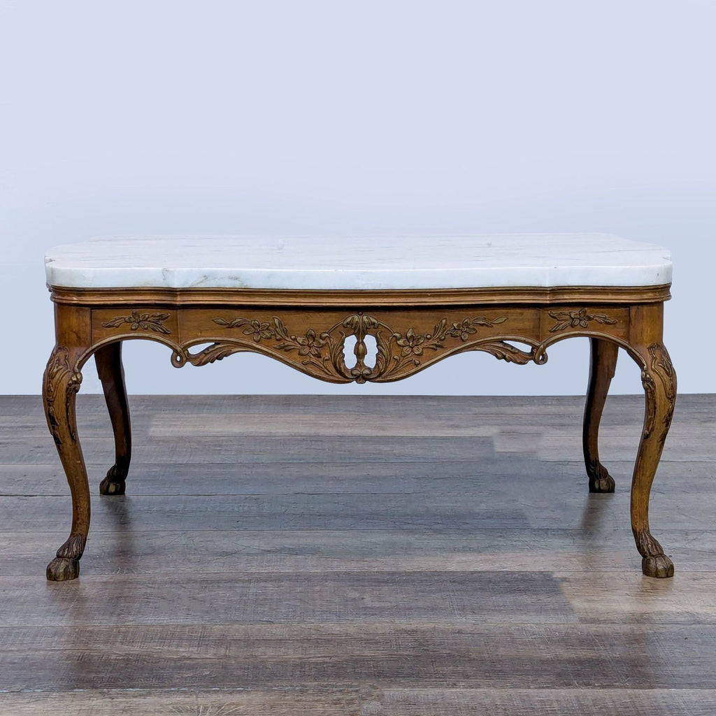 1. Reperch coffee table with carved wood floral base, cabriole legs, paw feet, and a white marble top.  