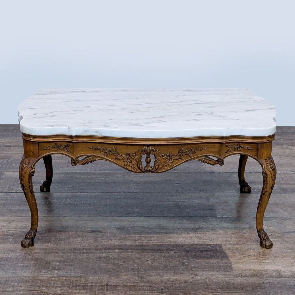 2. Ornate Reperch coffee table featuring floral wood carvings, curved cabriole legs, and a marble surface.  