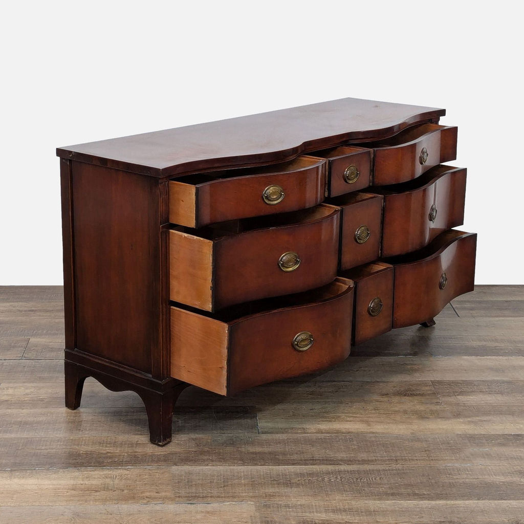 2. Side view of Drexel dresser, showing curved design and partially open dovetail drawers with brass pulls.