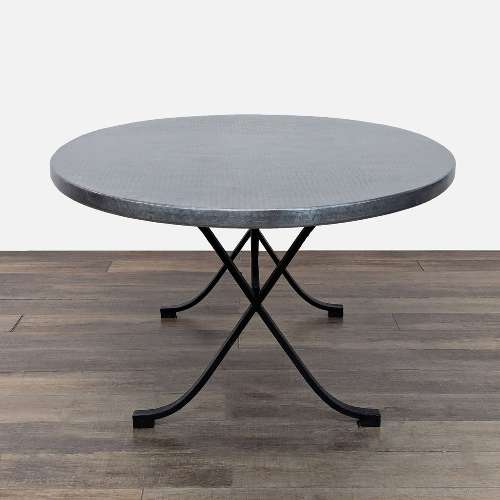 3. Metal top oval dining table from Kravet Furniture with curved black iron legs, dining set category.