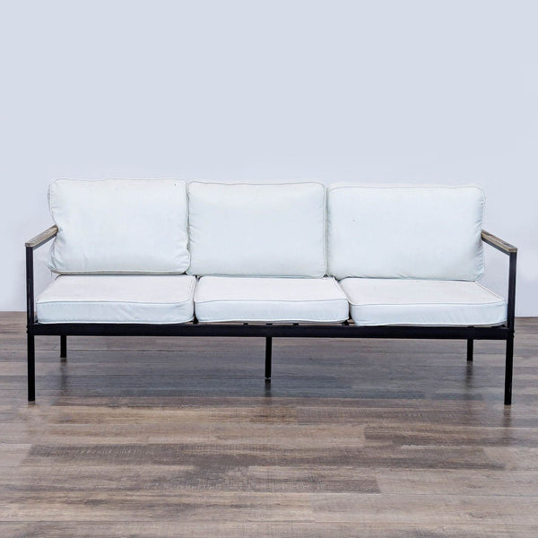 1. Outdoor sofa by Reperch with a metal frame, wood armrests, and three removable white cushions, viewed from the front.