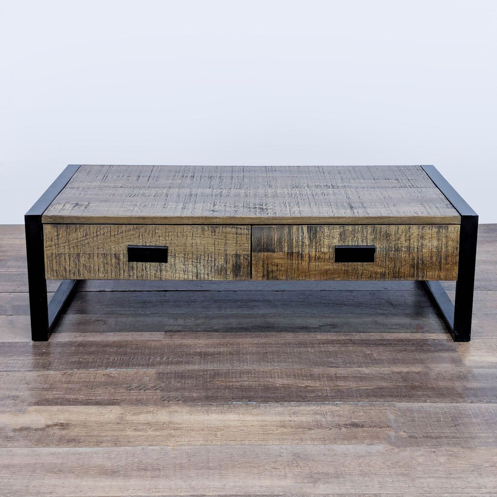 3. Rustic industrial coffee table by Reperch, constructed from reclaimed wood and black metal sled legs.