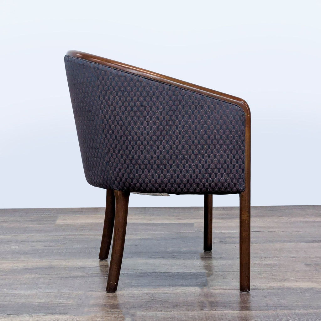 2. Side view of a Kimball International lounge chair, showing curved back and rounded wood armrests.