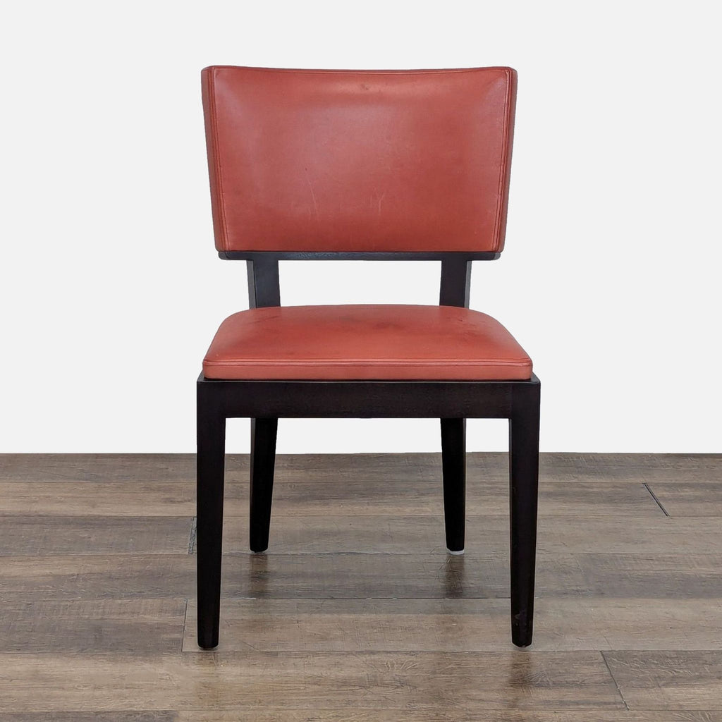2. Front view of a Christian Liaigre Harry dining chair in red Spinneybeck leather with a wood frame by Holly Hunt.
