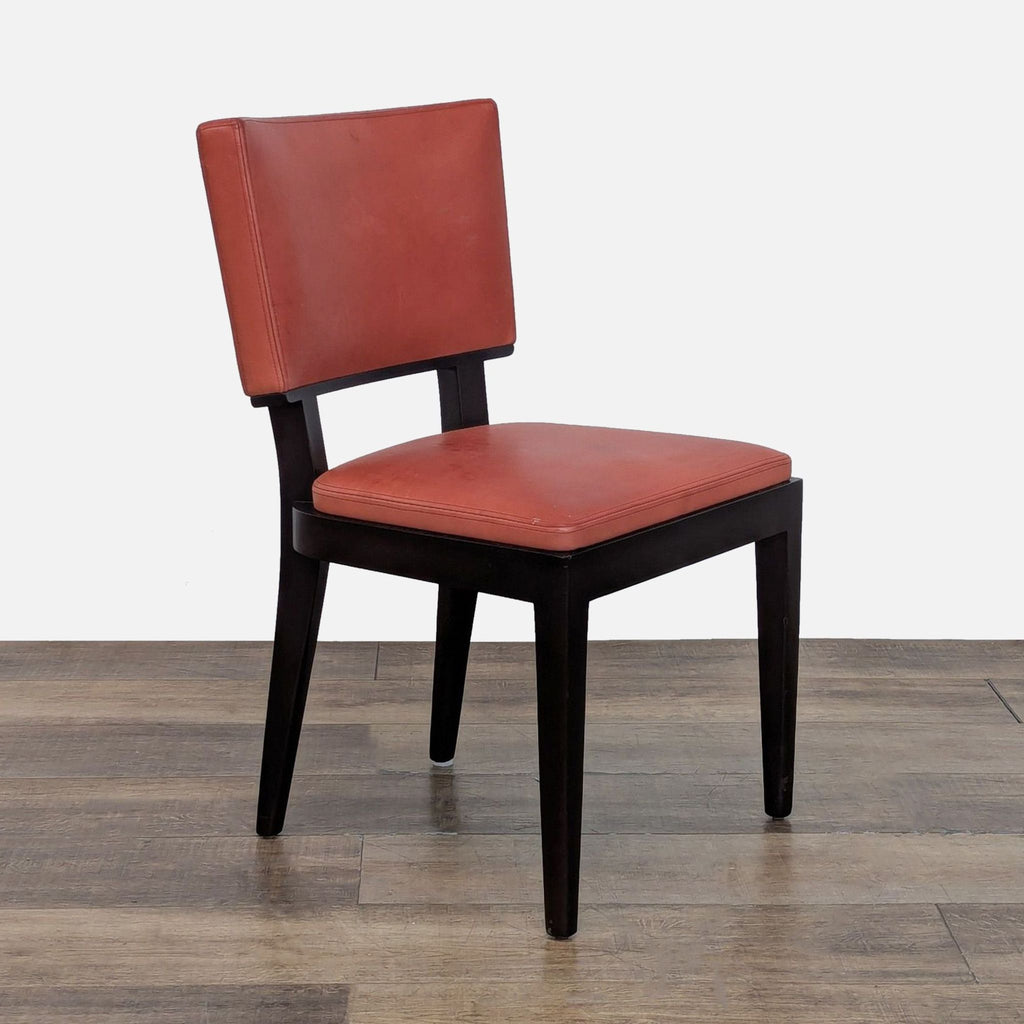 3. Angled side view of a Holly Hunt/Christian Liaigre Harry dining chair, highlighting its wood construction and red leather.