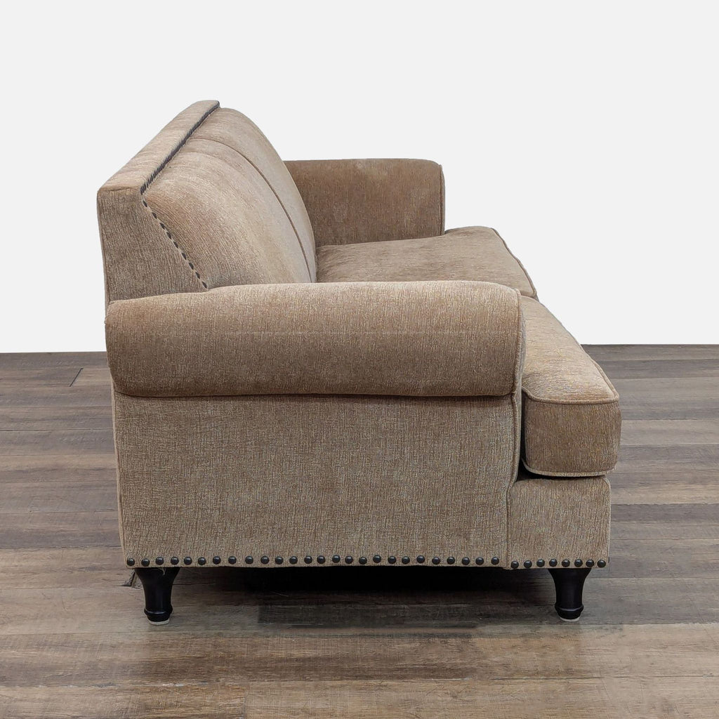 2. Side view of Pier 1 Imports 3-seat sofa showing plush armrest, chenille fabric, and bronze nailhead trim.