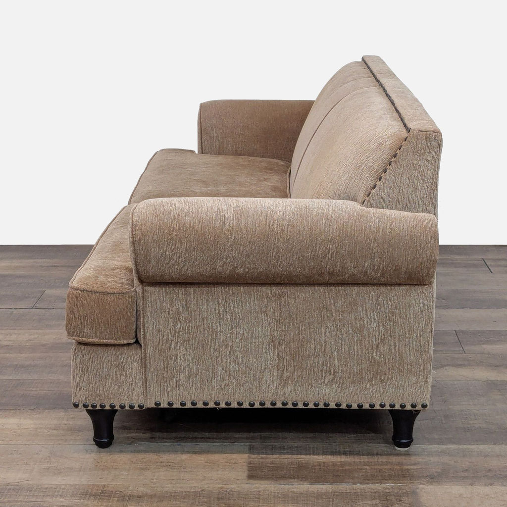 3. Right-side perspective of a golden brown chenille Pier 1 Imports 3-seat sofa with nailhead accents.