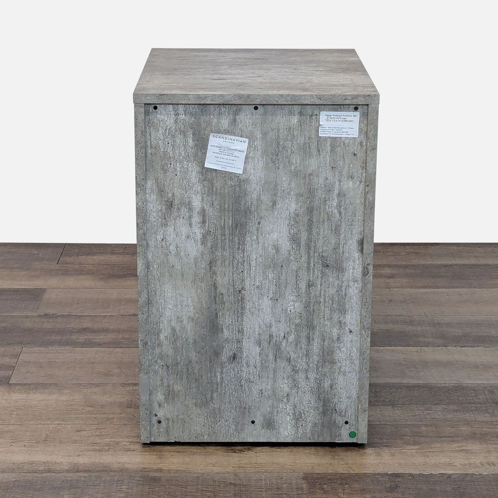 3. Back view of a Scandinavian Designs cabinet in a concrete finish, displaying brand and product labels.