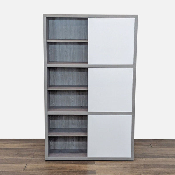 Modern bookcase with faux-cement finish and three high-gloss white sliding doors by Scandinavian Designs.