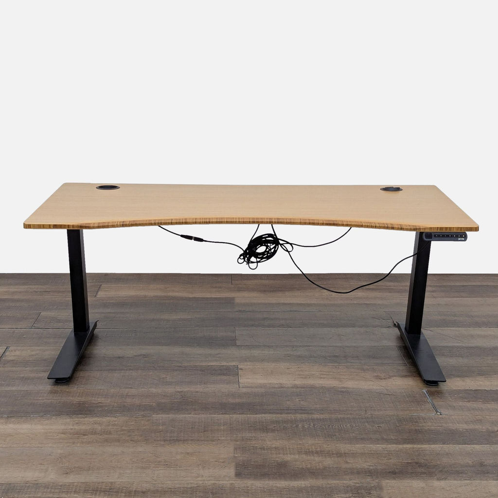 1. Jarvis desk with bamboo top, black adjustable legs, and a programmable controller, shown from the front.