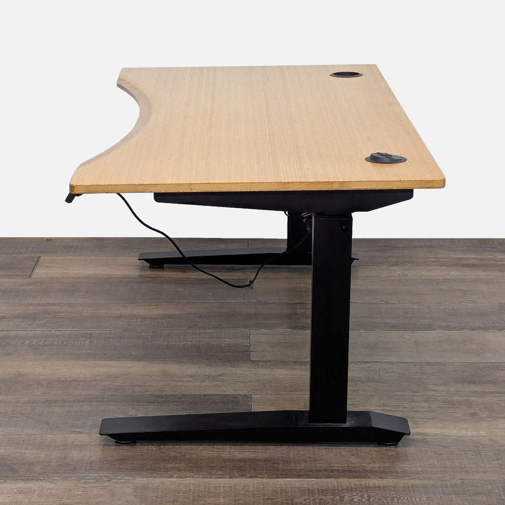 3. Side view of Jarvis desk featuring bamboo top and black adjustable legs, suitable for ergonomic workspaces.
