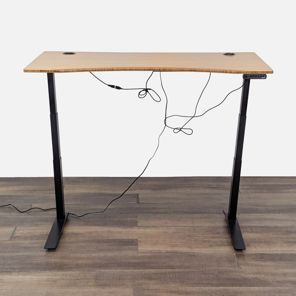 2. Jarvis adjustable standing desk with bamboo top, pictured at full height with visible programmable controller.