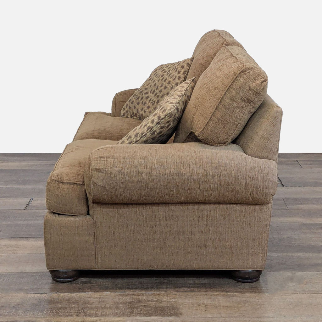 3. Angled side view of Ethan Allen loveseat with plush cushions, removable arm covers, and spotted accent pillows.