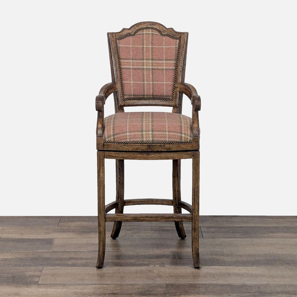 1. Front view of a Reperch wood swivel chair with plaid upholstery, high back, and nailhead trim.