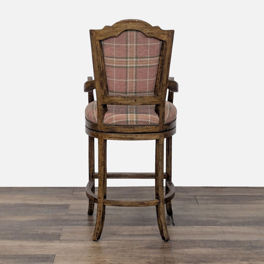 2. Rear view of a high-back Reperch stool featuring plaid fabric, wood frame, and decorative nailhead detail.