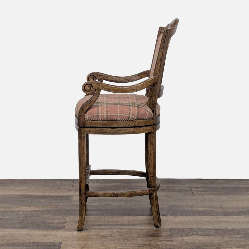 3. Side view of a traditional style Reperch swivel chair with arms, plaid upholstery, and wood frame.