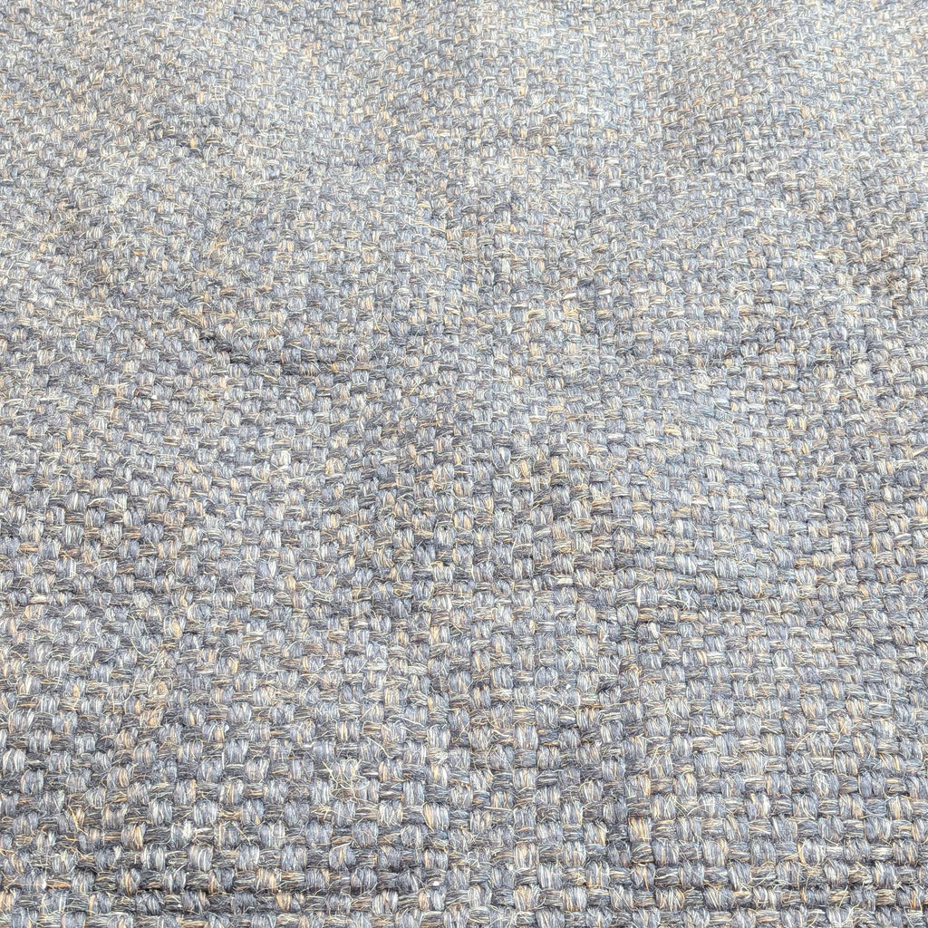 3. Overhead shot of Restoration Hardware's woven sisal rug with distinctive basket weave texture.