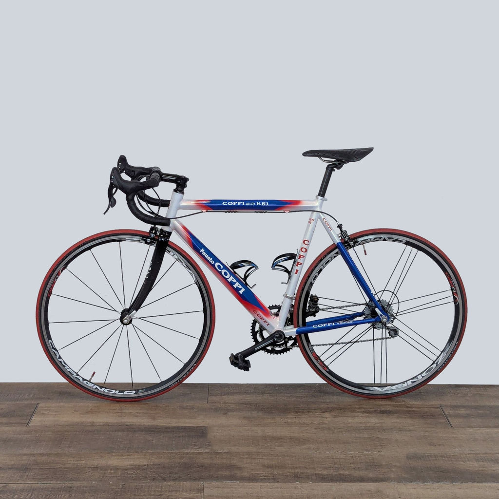Sleek Coppi Fausto Coppi road bike with lightweight alloy frame, carbon fiber parts, and racing groupset on display.