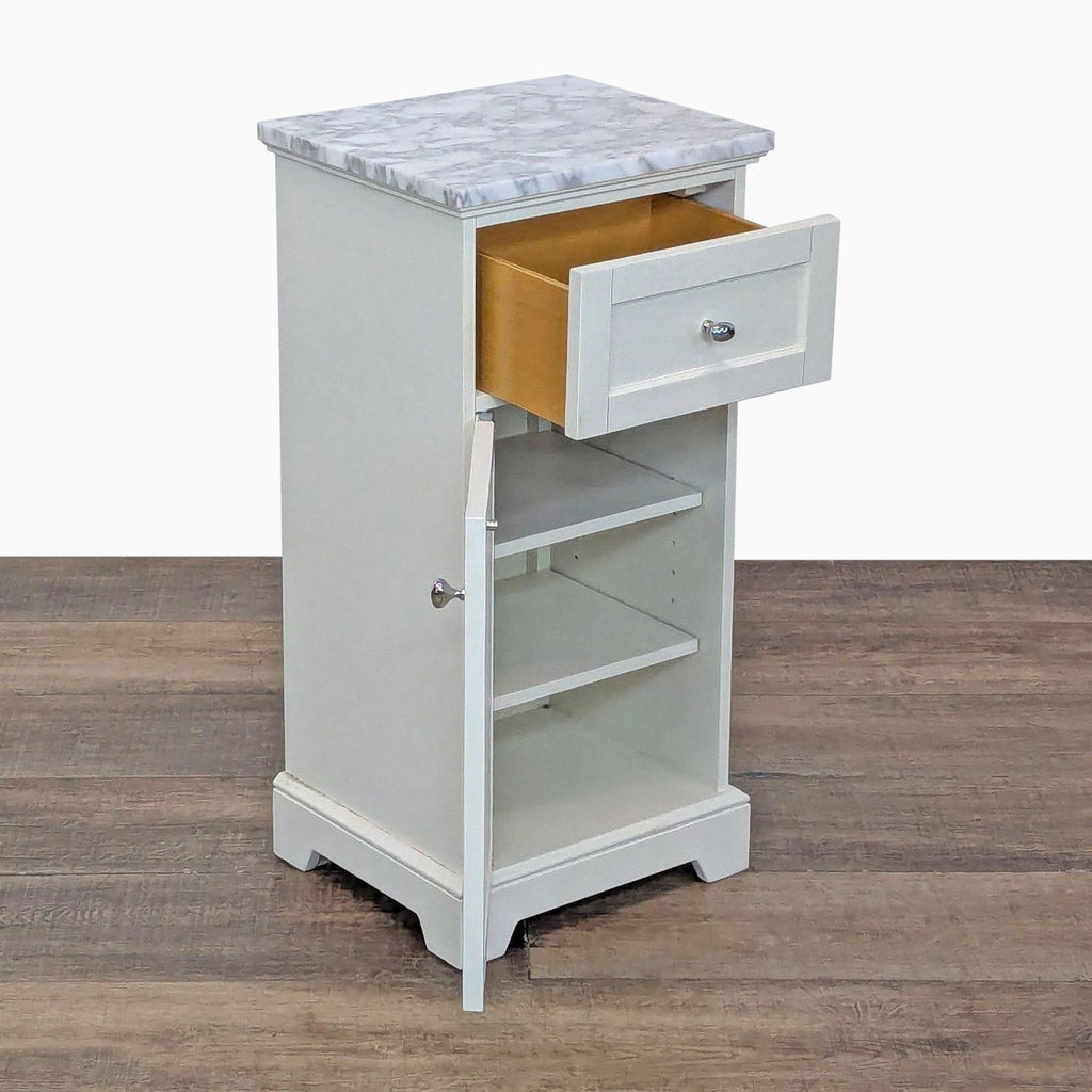 Side view of a Pottery Barn end table with its drawer and cabinet door open, showing interior shelves.