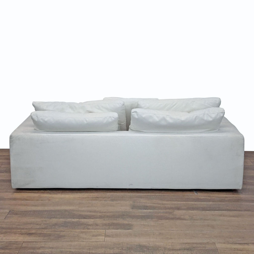 Back view of the Restoration Hardware Cloud 3-seat sofa with soft, fluffy back cushions atop a solid frame.