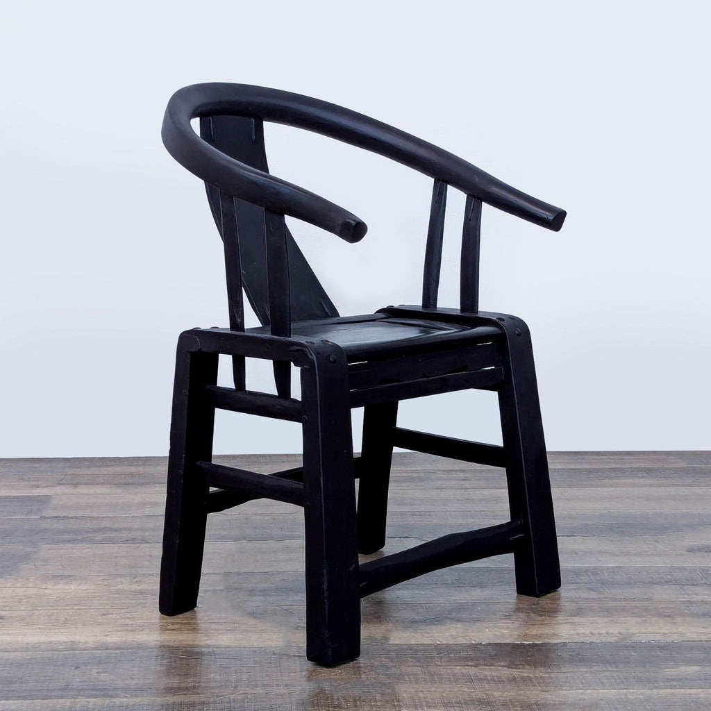 3. Angled view of Reperch lounge chair, featuring curved armrest, solid back splat, and rectangular seat.