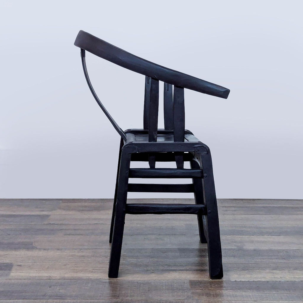 2. Side view of a Reperch lounge chair, showing horseshoe armrests, solid back splat, and sturdy frame.