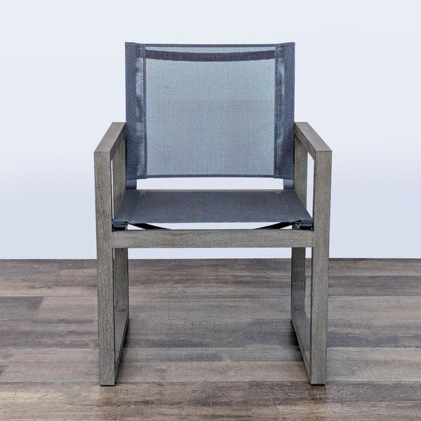 1. Front view of the Aegean outdoor dining armchair by Restoration Hardware with teak frame and charcoal mesh seat.